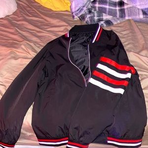 Black jacket with white, n red strips.